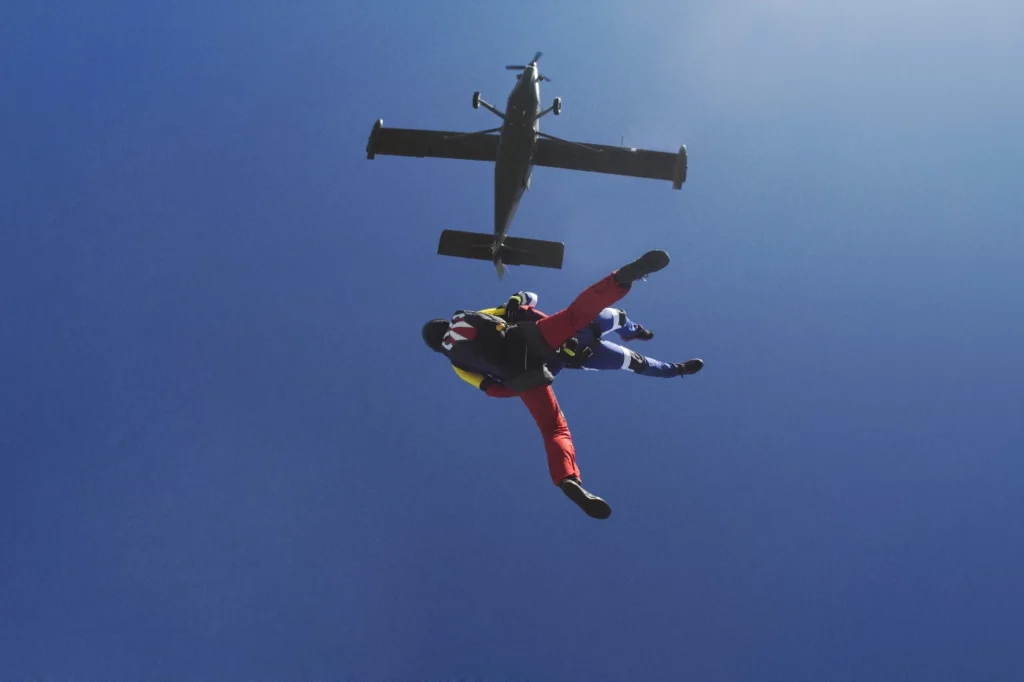 men jumping out of plane