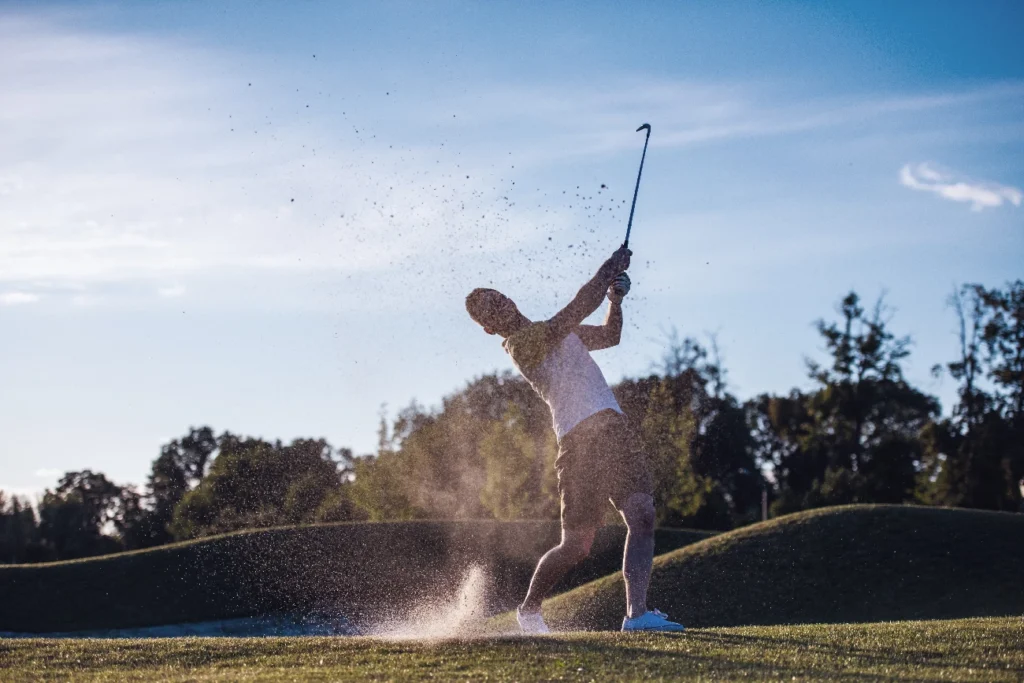 guy swinging golf club